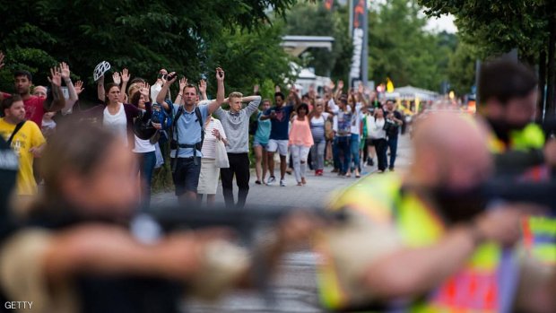 Police escorts evacuated people from the shopping mall (the Olympia Einkaufzentrum (OEZ) in Munich on July 22, 2016 following a shootings earlier. At least one person has been killed and 10 wounded in a shooting at a shopping centre in Munich on Friday, German police said. / AFP / STR        (Photo credit should read STR/AFP/Getty Images)