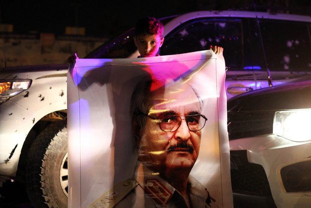 A Libyan boy holds a portrait of Major-General Halifa Haftar as people celebrate the decision by their parliament to reject the UN proposals for a national unity government, in a public square in Benghazi late on October 19, 2015. A majority of lawmakers in Libya's internationally recognised parliament rejected a UN peace deal and a proposal for a national unity government, one of them said. AFP PHOTO / ABDULLAH DOMA / AFP PHOTO / ABDULLAH DOMA