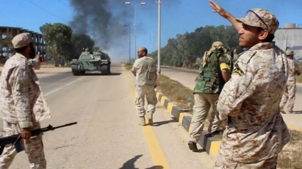 Soldiers from a force aligned with Libya's new unity government walk along a road during an advance on the eastern and southern outskirts of the Islamic State stronghold of Sirte, in this still image taken from video on June 9, 2016. via Reuters