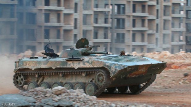 A fighter of the Syrian Islamist rebel group Jabhat Fateh al-Sham, the former al Qaeda-affiliated Nusra Front, rides in an armoured vehicle in the 1070 Apartment Project area in southwestern Aleppo, Syria August 5, 2016. REUTERS/Ammar Abdullah