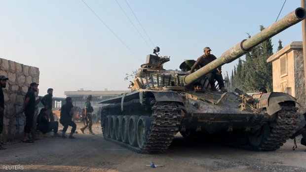 Rebel fighters ride a tank in an artillery academy of Aleppo, Syria, August 6, 2016. REUTERS/Ammar Abdullah