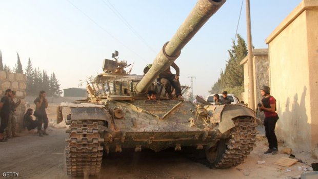 Fighters from the former Al-Nusra Front -- renamed Fateh al-Sham Front after breaking from Al-Qaeda -- drive a tank as they seized key positions south of Aleppo on August 6, 2016 in a major offensive to break the government siege of the city, the Syrian Observatory for Human Rights said.  Fateh al-Sham Front announced having captured two military academies and a third military position.  / AFP / Omar haj kadour        (Photo credit should read OMAR HAJ KADOUR/AFP/Getty Images)