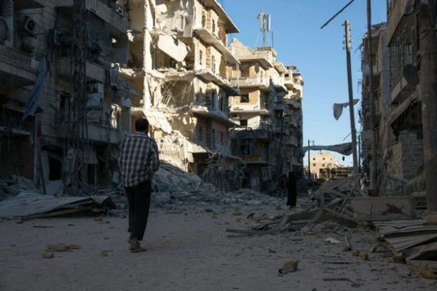 A Syrian man walks past a heavily damaged building following air strikes on rebel-held eastern areas of Aleppo ©Karam al-Masri (AFP)