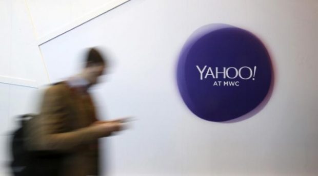 A man walks past a Yahoo logo during the Mobile World Congress in Barcelona, Spain in this February 24, 2016 file photo. REUTERS/Albert Gea/File Photo