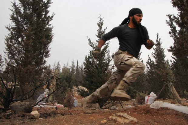 A rebel fighter takes cover after firing a mortar launcher against government forces west of Aleppo during a fresh rebel offensive in the northern city on Friday. PHOTO: OMAR HAJ KADOUR/AGENCE FRANCE-PRESSE/GETTY IMAGES