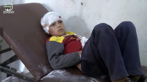 This frame grab from video provided by Muaz al-Shami, Syrian Revolution Network, an opposition activist media organization, that is consistent with independent AP reporting, shows a child on a hospital bed, with a bandage around his head after airstrikes killed over 20 people, in the northern rebel-held village of Hass, Syria, Wednesday, Oct 26, 2016. A team of first responders, the Syrian Civil Defense in Idlib, said at least 50 were wounded in the raids that used parachute mines, targeting the residential area and schools in the village of Hass.  Most of those killed were children, the group said on its Facebook page. (Muaz al-Shami, Syrian Revolution Network, via AP)