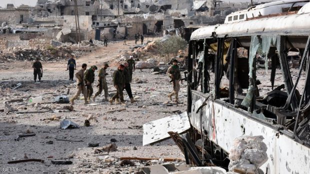 Syrian pro-government forces walk around in the village of Minyan, west of Aleppo, after they retook the area from rebel fighters on November 12, 2016. GEORGE OURFALIAN/AFP/Getty Images