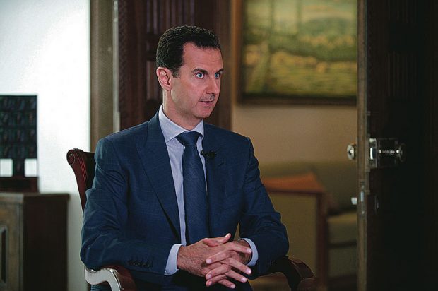 Syrian President Bashar Assad speaks at the presidential palace in Damascus, Syria. Syrian Presidency via AP