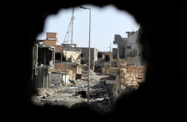 A view from a hole in a wall shows houses and buildings that were destroyed during a battle between Libyan forces allied with the U.N.-backed government and Islamic State militants, in neighborhood Number Three in Sirte, Libya, October 10, 2016. REUTERS/Ismail Zitouny